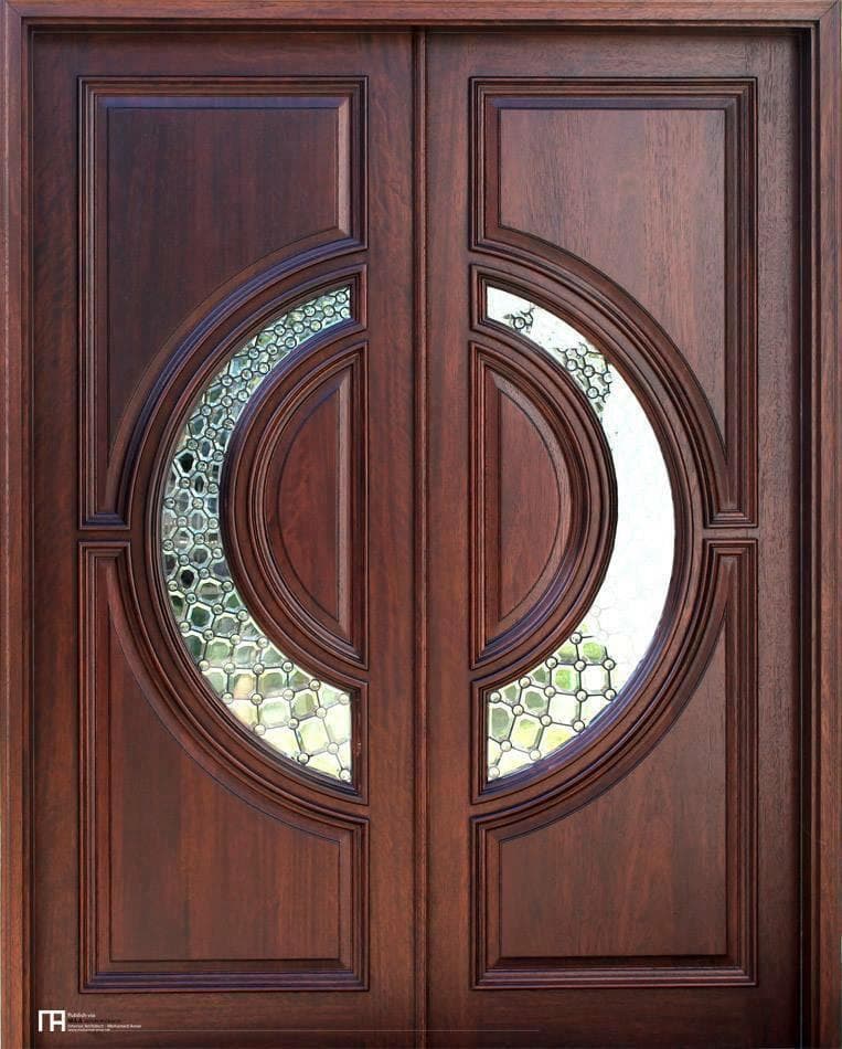 Custom carved wood entrance door with circular glass inlay