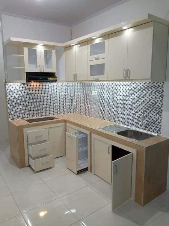 Cream-toned kitchen cabinetry with patterned backsplash