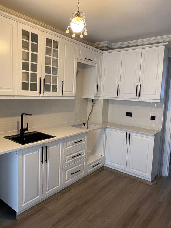 Classic white kitchen cabinetry with black sink